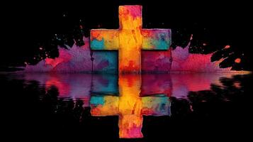 Colorful cross with vibrant splashes and reflections on a black background creating a striking visual impact photo