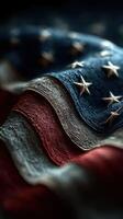 Textured American flag waves showcasing stars and stripes in dramatic lighting photo