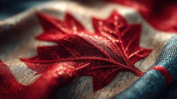 Detailed close-up of a Canadian flag showcasing the iconic red maple leaf design and textured fabric in soft lighting photo