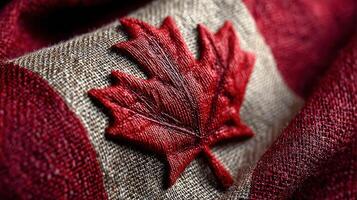 Red maple leaf emblem representing national pride of Canada on rustic fabric background photo