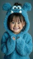 Smiling child in fluffy blue monster hoodie poses for portrait in playful indoor setting photo