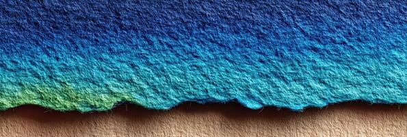 Colorful gradient of fabric texture showing a blend from deep blue to turquoise and green on a neutral background photo