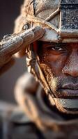Soldier salutes with determination and resilience amidst sandy terrain at dusk, showcasing strength and commitment in challenging conditions photo