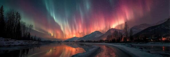 Colorful auroras illuminate the night sky over mountains and a river in winter photo