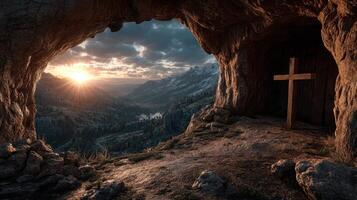 Stunning sunrise over a mountain valley from a cave with a wooden cross in the foreground photo