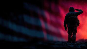 Soldier saluting against a fiery backdrop with an American flag in silhouette at night photo