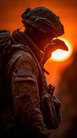 Soldier salutes at sunset in a cold, snowy landscape during a military operation photo