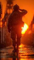 Soldier saluting during sunset at a military memorial site with flags in the background photo