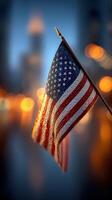 American flag waves proudly against a blurred city background during twilight hours photo