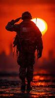 Soldier salutes during sunset in a vibrant sky, symbolizing honor and respect for service photo