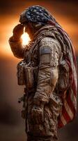 Soldier saluting at sunset with American flag draped over shoulders during military ceremony photo