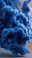 Swirling blue cloud with golden particles hovering in the air in a dramatic display of color and texture photo