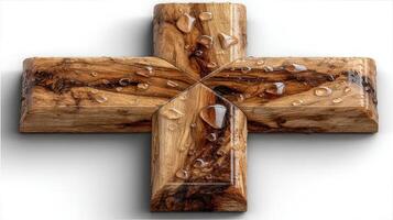 Beautiful wooden cross with water droplets, showcasing craftsmanship and natural textures from a creative workshop setting photo