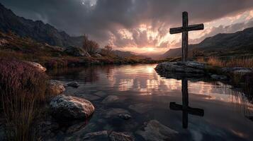 Sunset over a serene lake with a wooden cross reflecting in the water surrounded by mountains and autumn foliage photo