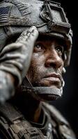 Soldier in combat gear saluting with determination during a military training exercise in a challenging environment photo