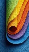 Colorful rolled sheets of textured paper display vibrant hues stacked in a creative arrangement photo