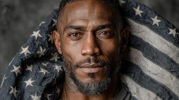 Portrait of a man wrapped in an American flag showcasing pride and strength in a studio setting photo