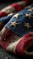 Worn fabric of an American flag with stars and stripes showcasing vibrant colors and texture in soft light photo
