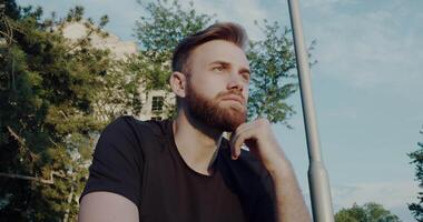 A Thoughtful Man Enjoys an Outdoor Setting While Embracing the Natural Elements Around Him video