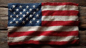 Vintage American flag with rustic texture displayed on weathered wooden surface photo
