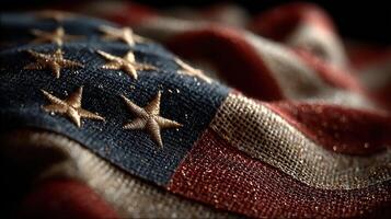 Stars and stripes reveal intricate details of an American flag draped over a surface in a warm, soft light during an evening photo