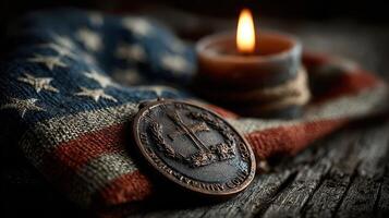 Souvenir medal displayed on an American flag with a lit candle in a rustic setting photo