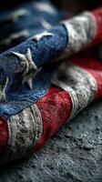 Worn American flag fabric displaying stars and stripes with rich texture and color contrasts under soft lighting photo