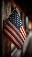 American flag displayed on a wooden wall in a rustic setting during twilight hours photo