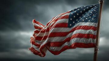 Waving American flag against a moody sky during sunset captures a moment of patriotism and resilience in nature photo