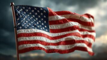 American flag waving in the wind against a dramatic cloudy sky during the late afternoon photo