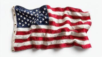 Worn American flag displayed artistically on a neutral background highlighting its texture and colors photo