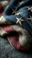 Worn American flag draped artistically showcasing detailed textures and colors of patriotism photo