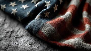 Worn American flag draped on rough stone surface showcasing texture and color details photo