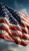 American flag waving under a clear blue sky during a sunny afternoon in a public park setting photo