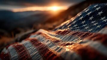 Dewy American flag resting on the ground during sunset with soft sunlight illuminating the fabric and surrounding landscape photo