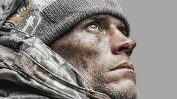 Portrait of a rugged man wearing a hat with a determined expression set against a neutral background photo