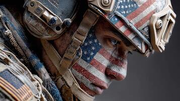 Soldier displays pride with American flag face paint during training exercise in rugged terrain photo