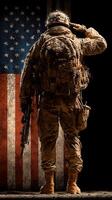 Soldier salutes while standing before a large American flag in a patriotic display of respect and honor photo