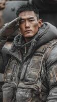 Soldier saluting with determination in a rugged military environment during a cold, overcast day photo