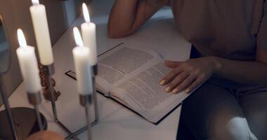 Reading a good book by candlelight in a cozy setting is an enriching experience of peace video