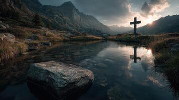 Reflection of a cross in a tranquil lake surrounded by mountains at sunset in a serene landscape photo