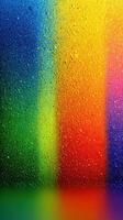 Vibrant colors blending with droplets of water on a glass surface create a stunning abstract view photo