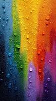 Colorful water droplets cascading down a vibrant surface with a rainbow pattern in bright hues photo