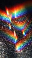 Colorful light reflections create vibrant patterns on a dark surface during the day photo