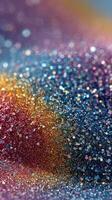 Colorful glitter creates a mesmerizing abstract pattern in vibrant shades of blue, gold, and pink photo