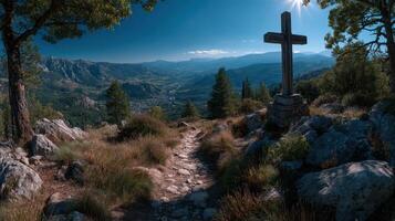 Scenic overlook with wooden cross and pathway in mountain landscape during daytime photo