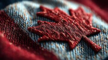 Textured close-up of a maple leaf emblem stitched onto denim fabric showcasing Canadian symbolism and craftsmanship photo