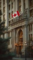 Majestic Canadian flag waving at historic building during golden hour in vibrant urban setting photo
