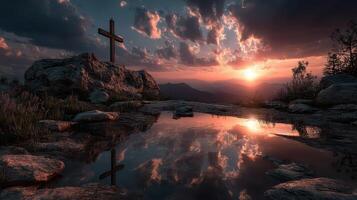 Sunset over rocky landscape with a cross and reflective pool in a serene mountain setting photo