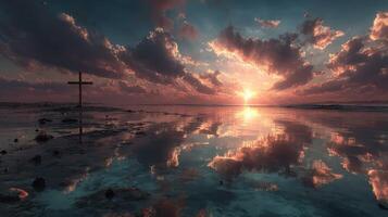 Beautiful sunset over calm ocean waters with reflecting clouds and a cross in the foreground photo